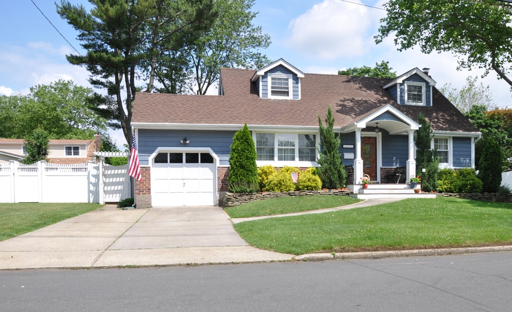 A front yard landscape with evergreen trees
